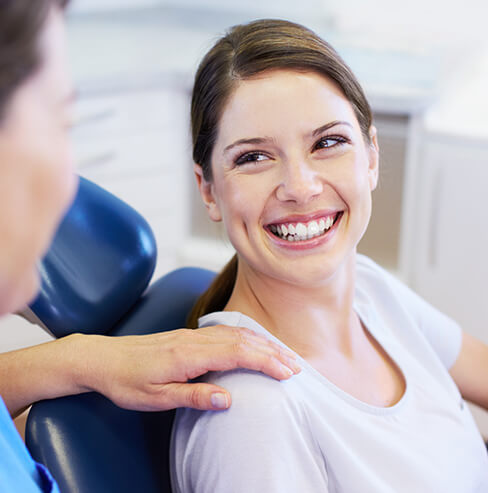 smiling woman sitting in a dental chair