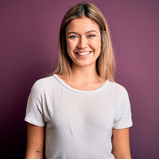 woman smiling against colorful wall