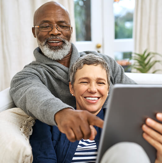 senior couple looking at a tablet device together
